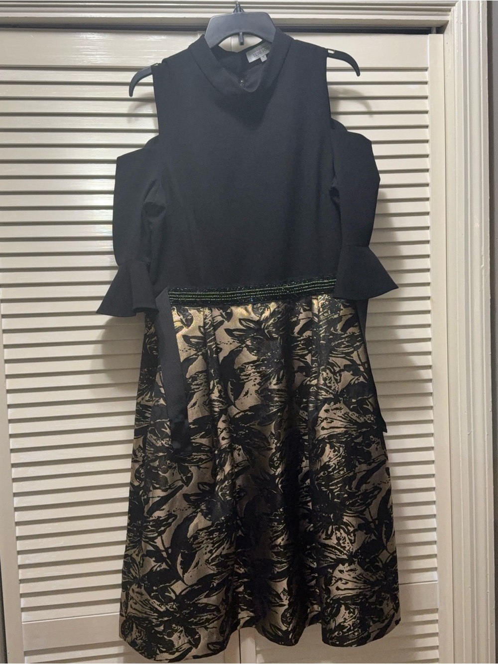 Teri Jon black and gold cold shoulder dress.